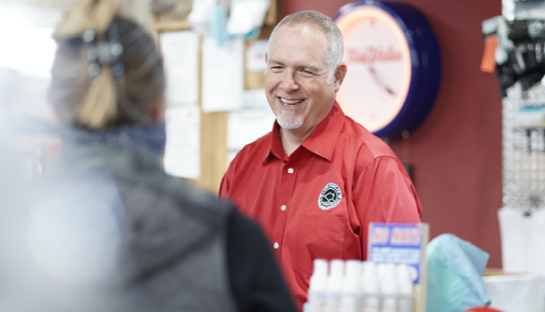 smiling man in red button up shirt