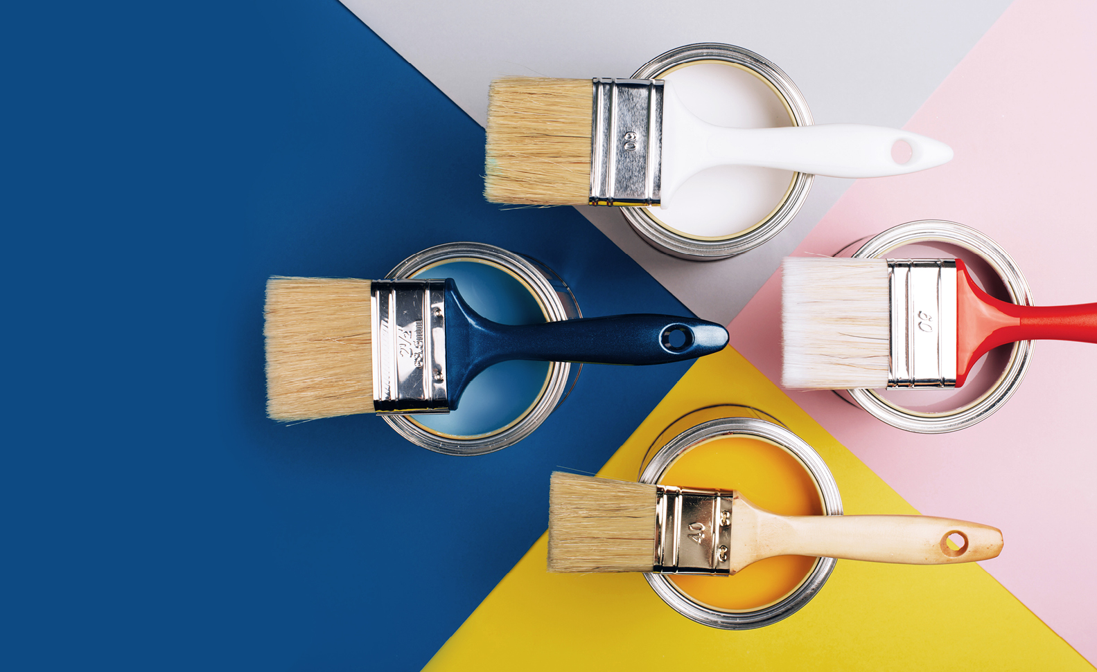 image of paint brushes resting on paint cans